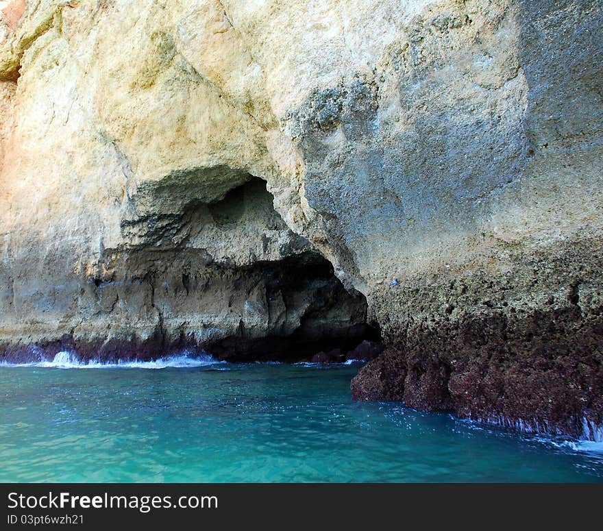 Caves in the cliffs yellow in Lagos in the Algarve