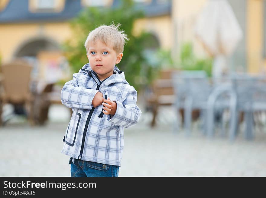 Cute little boy outdoors in city street. Cute little boy outdoors in city street