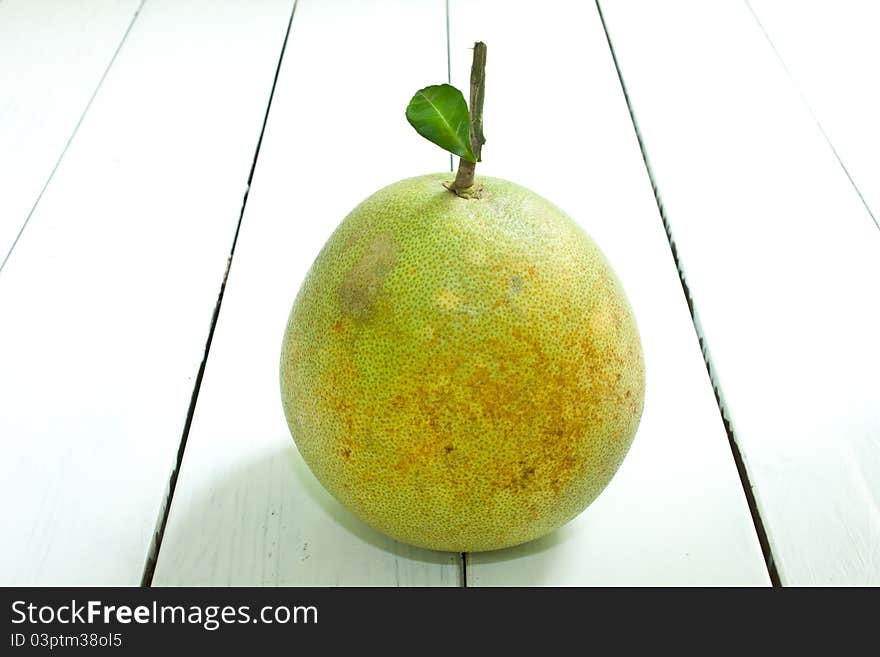 Green grapefruit on white table. Green grapefruit on white table