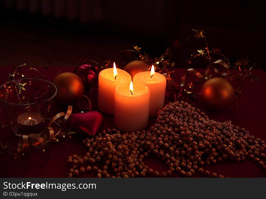 Candle lights, bauble and ribbon on red bakground. Candle lights, bauble and ribbon on red bakground.