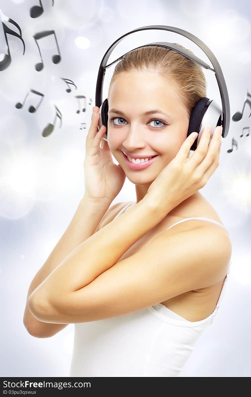 Girl listening to music on a light background