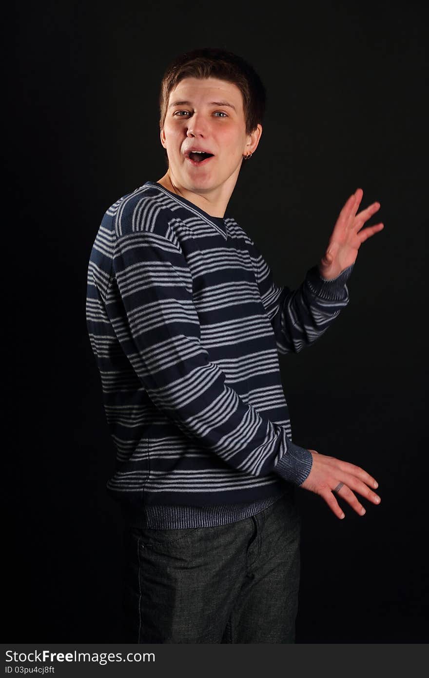 A young boy profile portrait on a black background