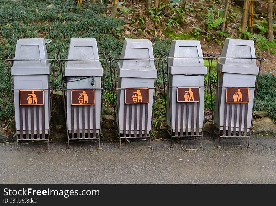 Row of trash bins in the park