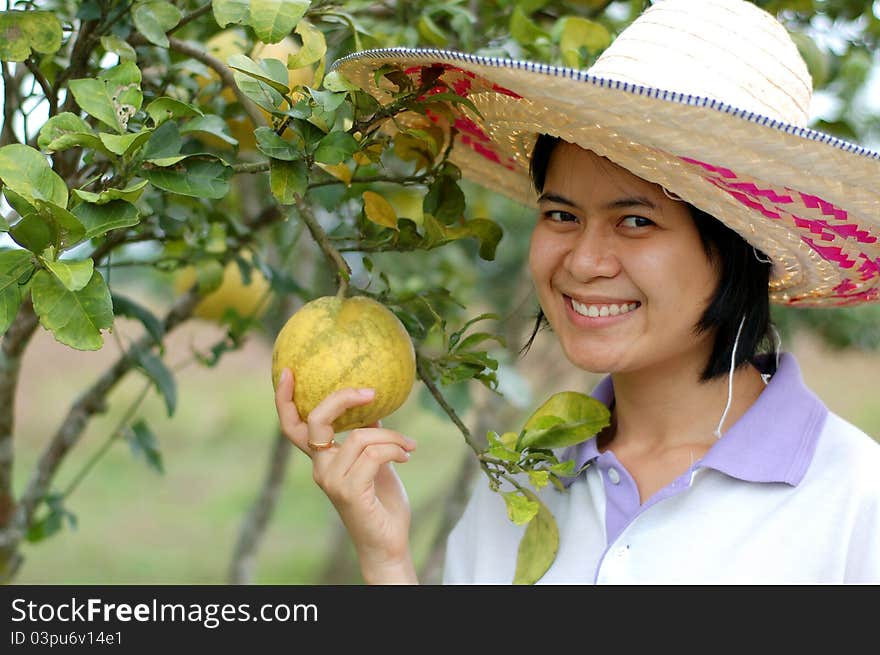 Portrait of gardener lady in a grapefruit garden