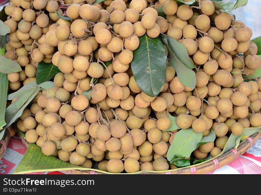 A bunch of longan sell in the market. A bunch of longan sell in the market