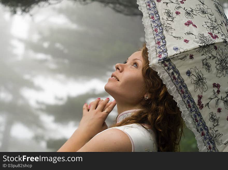 Young women with umbrella at rain in the Chinese m