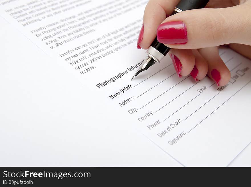 Female hand signing contract