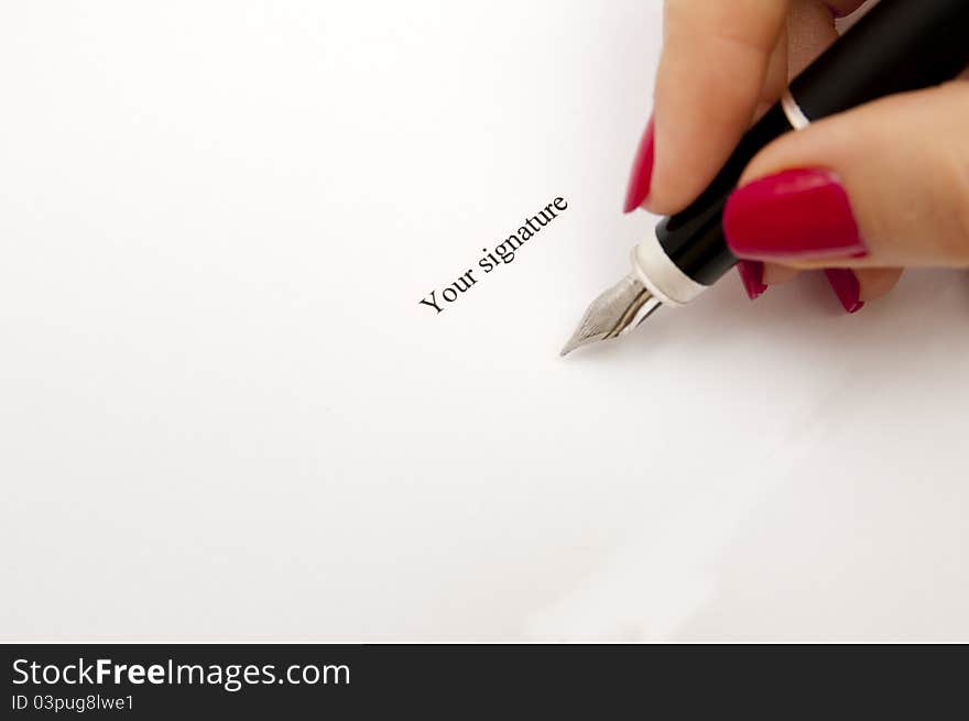 An image of Female hand signing contract