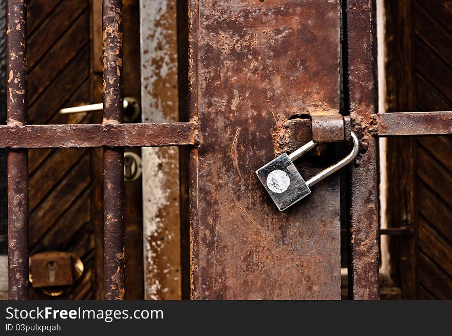 Old rusty padlock on cell door