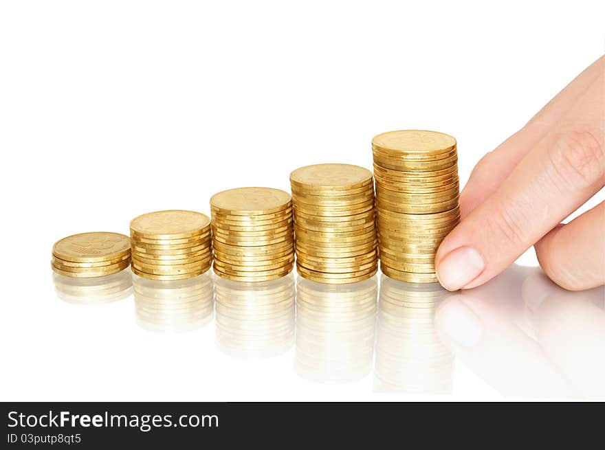 Stacks of coins like diagram with reflection and hand put coins