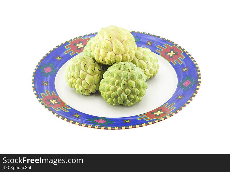 Custard apples group and opened one on a plate with isolate wihite background.