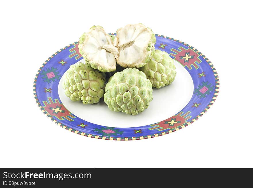 Custard apples group and opened one on white background with isolate. Custard apples group and opened one on white background with isolate.