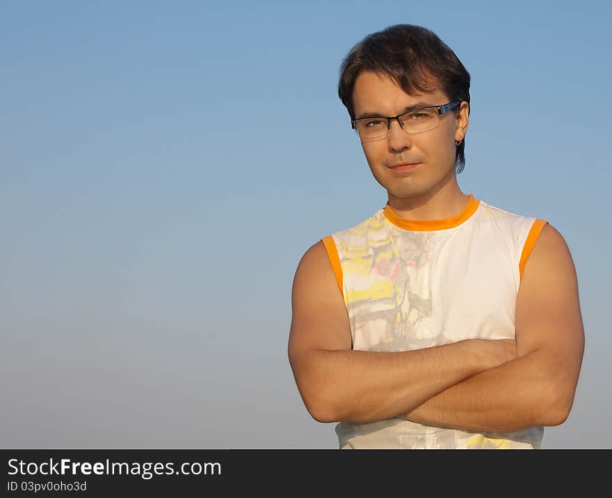 Portrait of a handsome young man with crossed hands. Portrait of a handsome young man with crossed hands