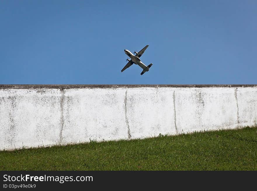 Military aircraft in training and doing a flyby next to a wall. Military aircraft in training and doing a flyby next to a wall.