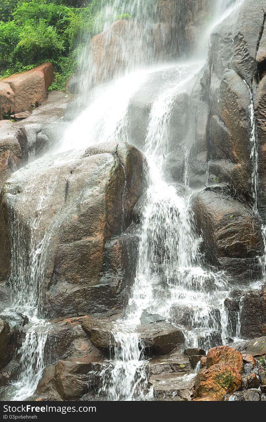 A waterfall is pouring down, showing grandeur and power. A waterfall is pouring down, showing grandeur and power.