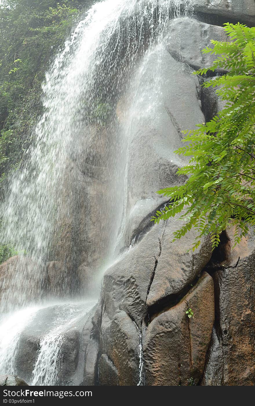A waterfall is pouring down, showing grandeur and power. A waterfall is pouring down, showing grandeur and power.