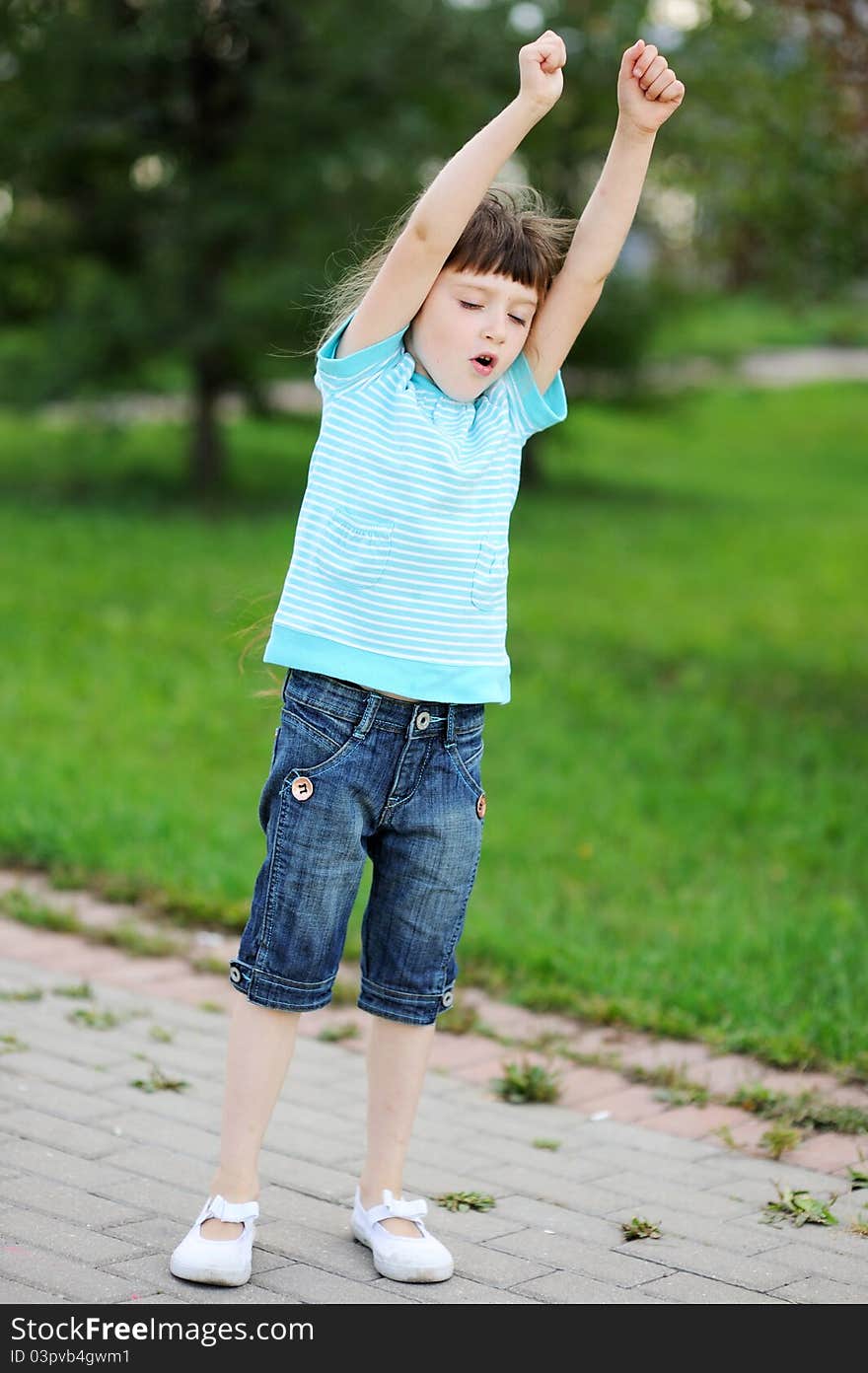 Portrait Of A Brunette Child Girl With Hands Up