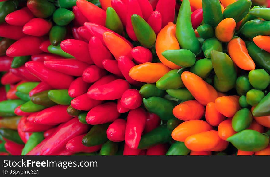 Bunch of bright colorful hot chili peppers closeup. Bunch of bright colorful hot chili peppers closeup