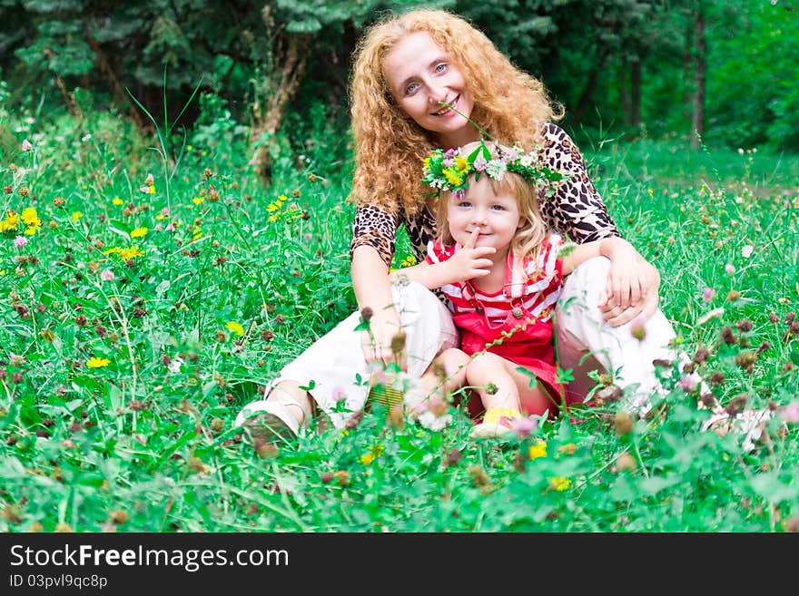 Beautiful girl with mother in the meadow outdoor