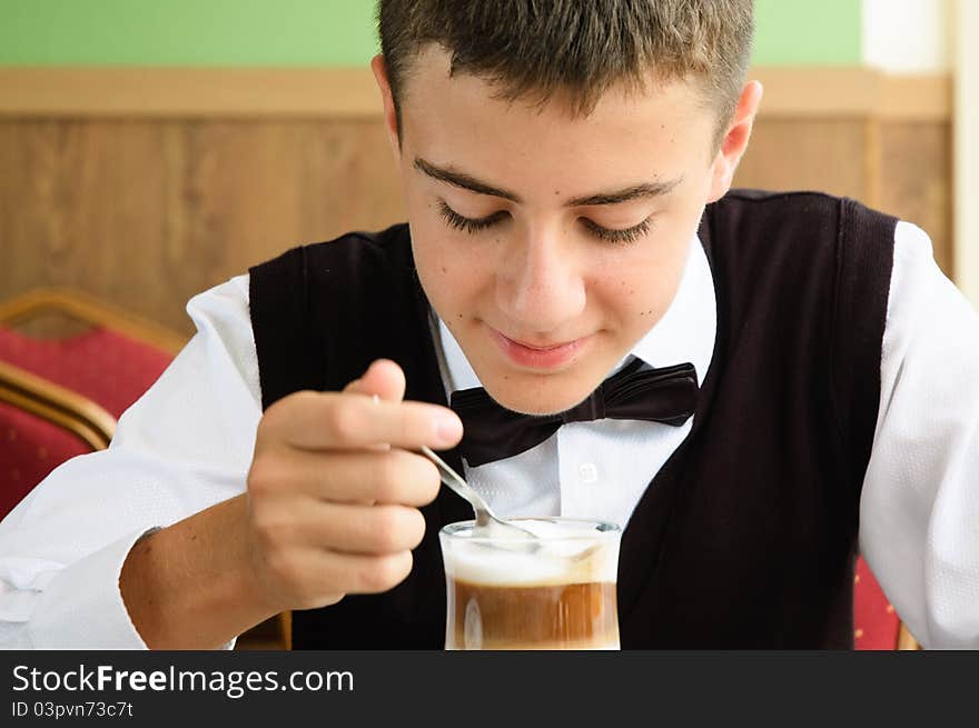 A Teenager Boy Enjoying Coffee In A Cafe