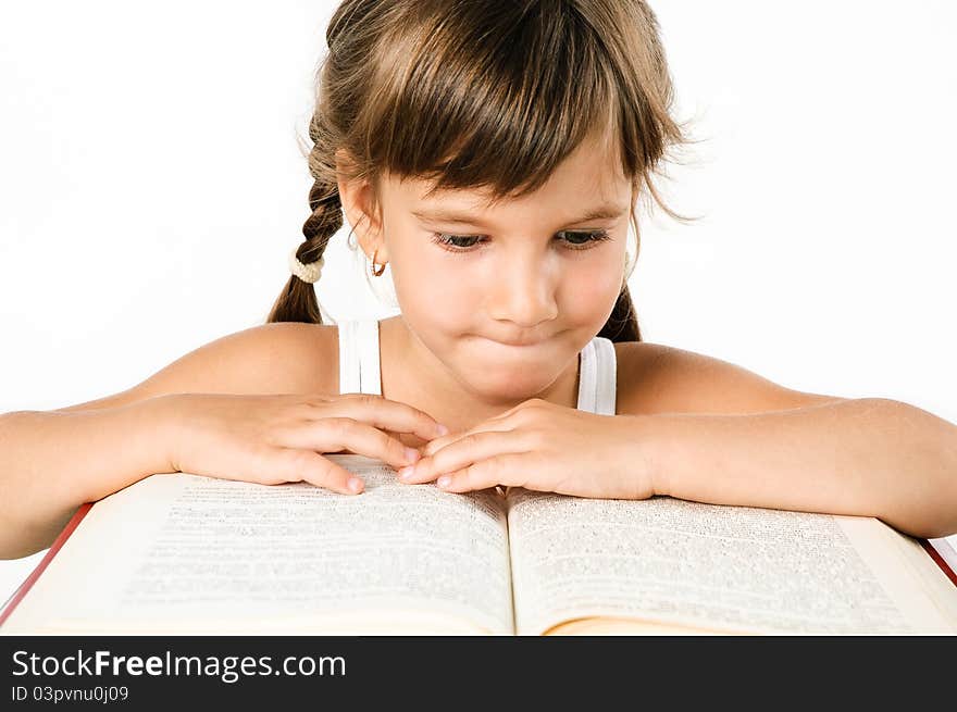 Cute girl looking for information in a big book isolated on white. Cute girl looking for information in a big book isolated on white