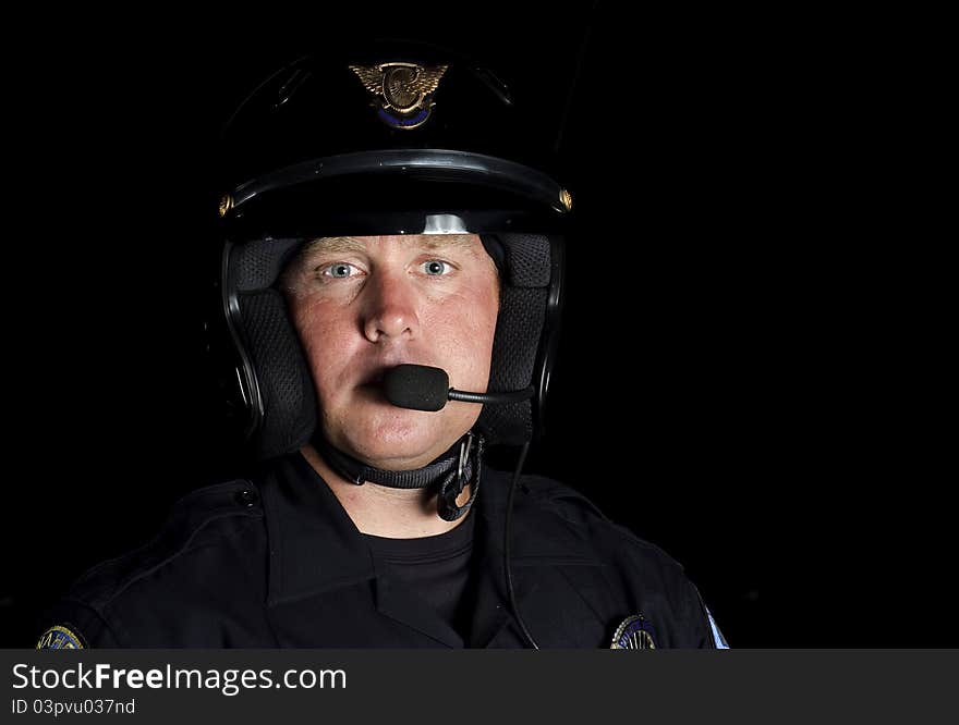 A police motorcycle officer in the night. A police motorcycle officer in the night.