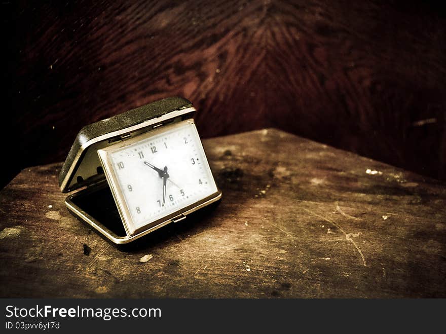 Vintage clock on a wood table. Vintage clock on a wood table