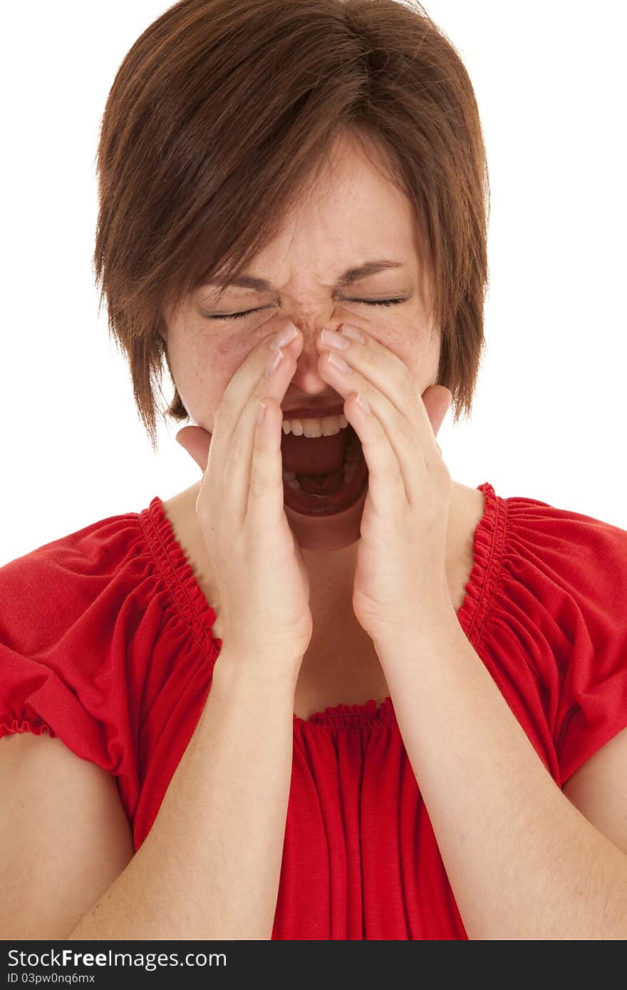 A woman with her hands around her mouth yelling. A woman with her hands around her mouth yelling.