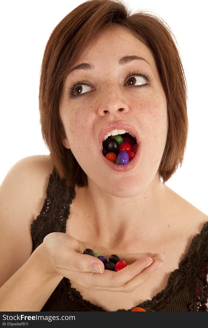 A woman with a mouth and handful of jelly beans. A woman with a mouth and handful of jelly beans.