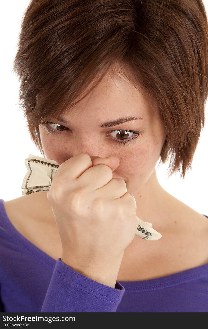 A woman with a twenty in her fist with a serious expression on her face. A woman with a twenty in her fist with a serious expression on her face.