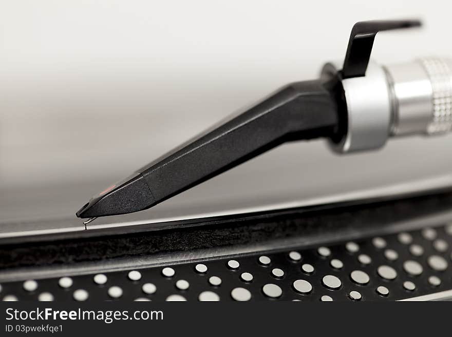 Close up of stylus arm on a record. Close up of stylus arm on a record.