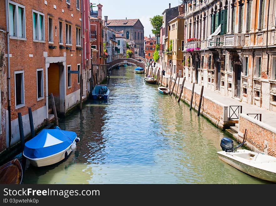 Canal, boats and bridge in Venice