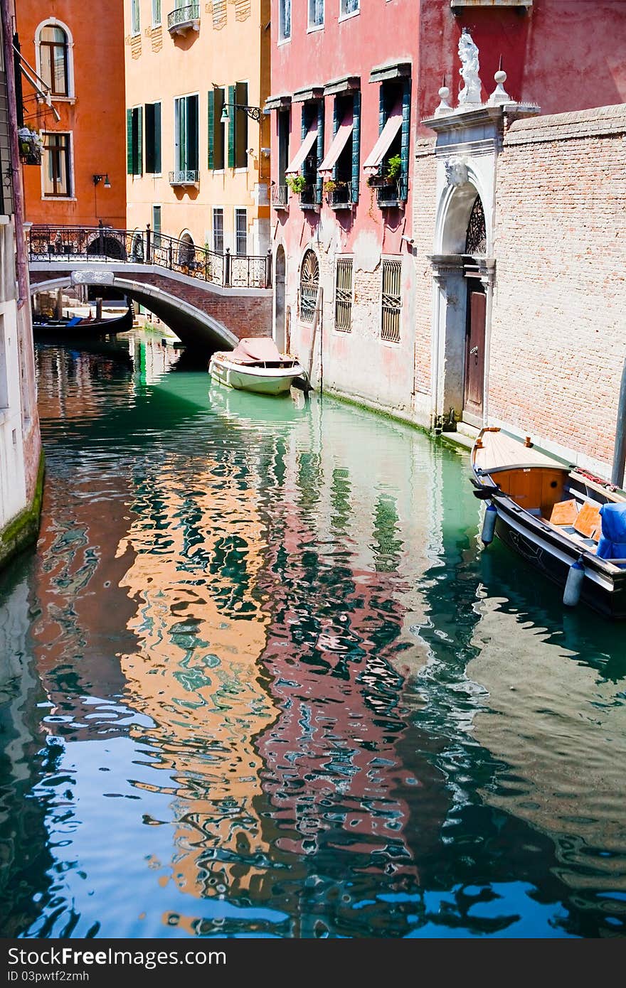 Canal, boats and bridge in Venice, Italy