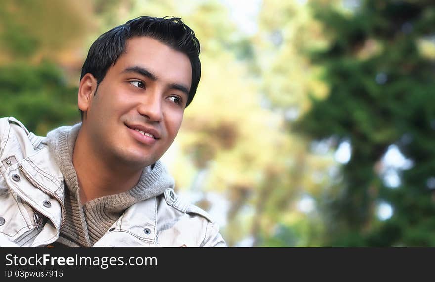 Portrait of a happy young man, autumn day