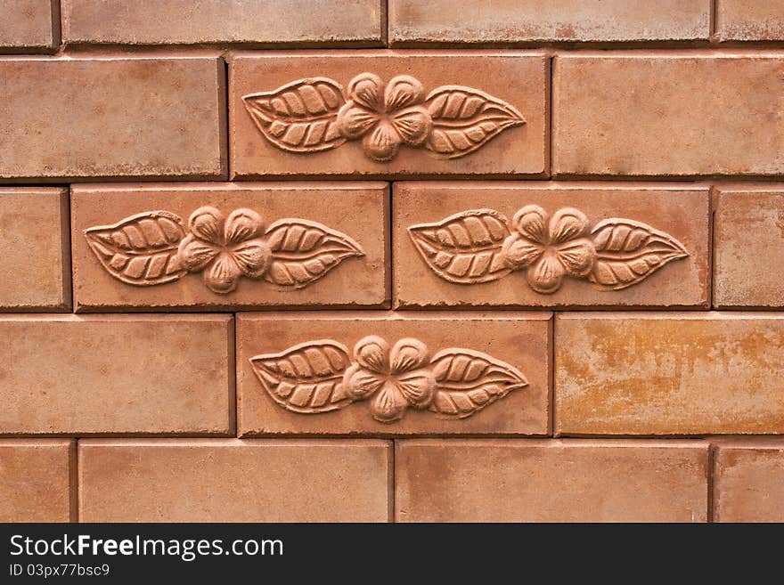 Flower and leaf on brick wall