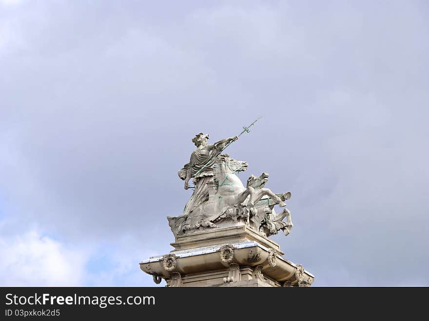 A Statue of a Woman in a Horse Drawn Chariot holding a Trident. A Statue of a Woman in a Horse Drawn Chariot holding a Trident