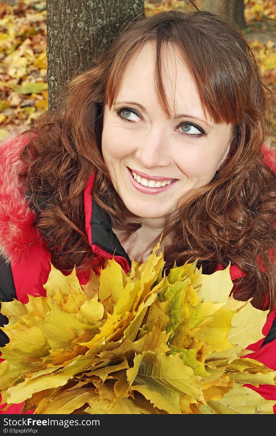 Beautiful woman holds the bouquet of yellow leaves. Beautiful woman holds the bouquet of yellow leaves