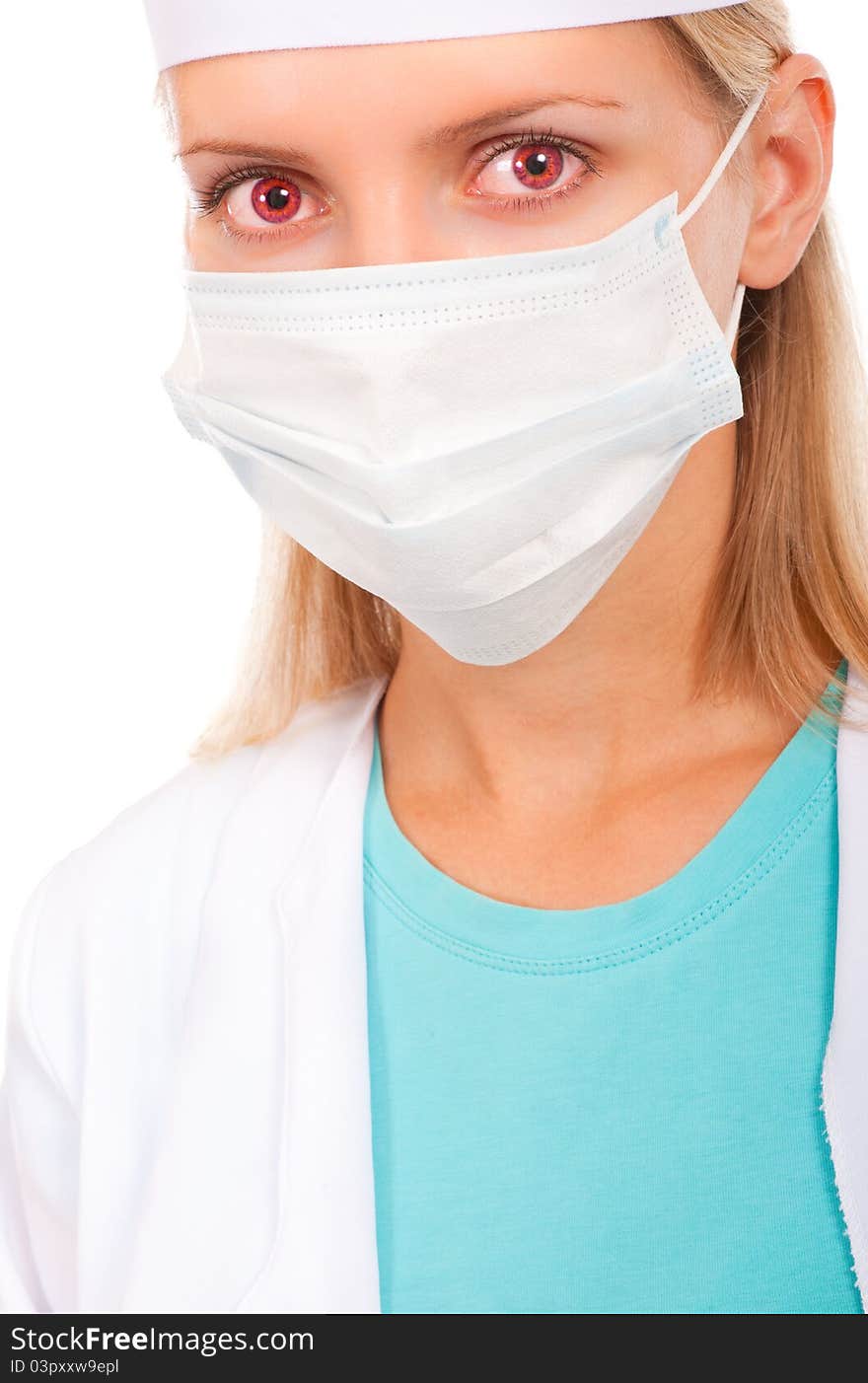 Face of a young doctor in a protective mask, close-up with red eyes