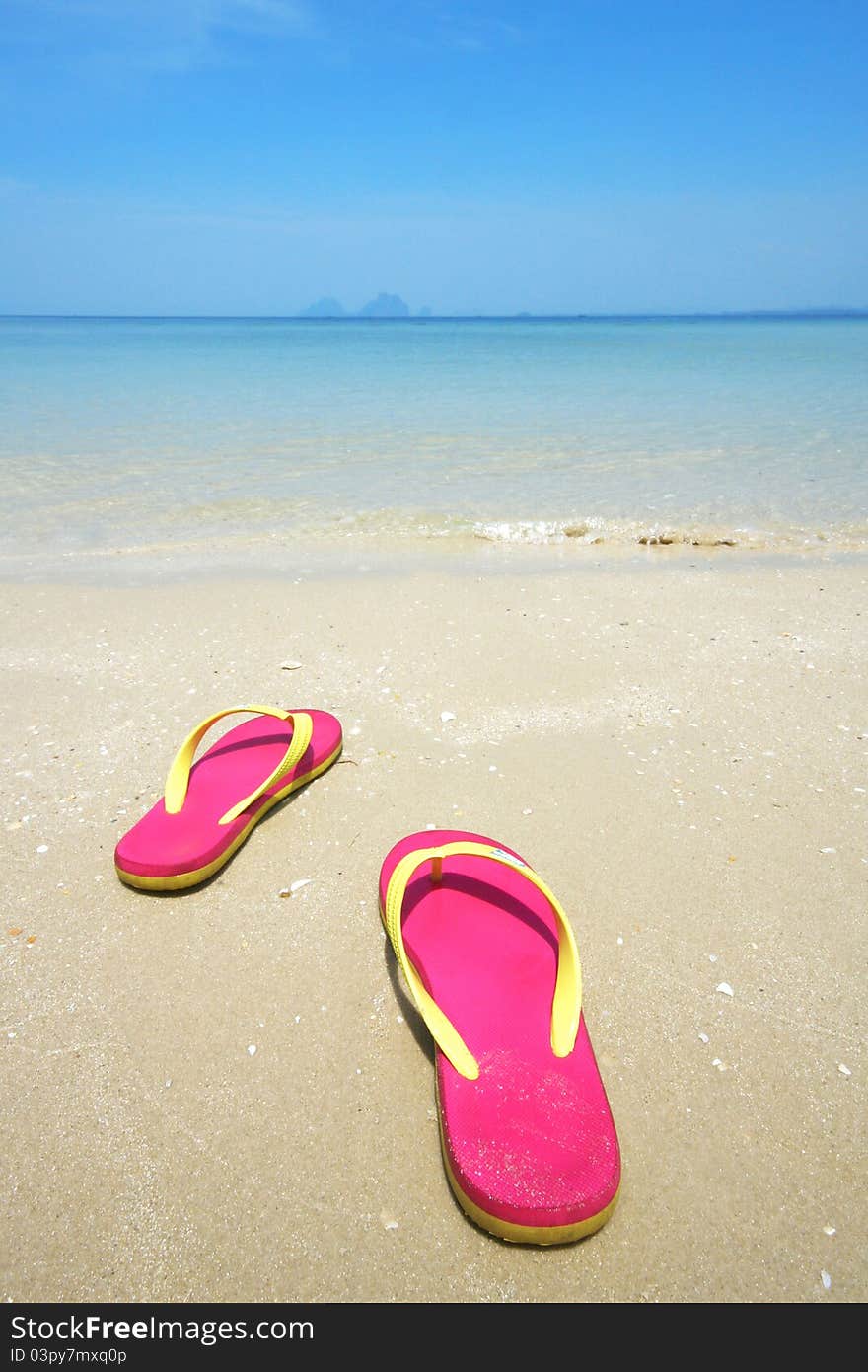 Pink sandals on the beautiful beach