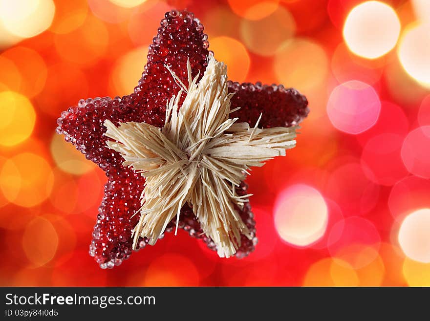 Star Christmas decoration against red blurred background