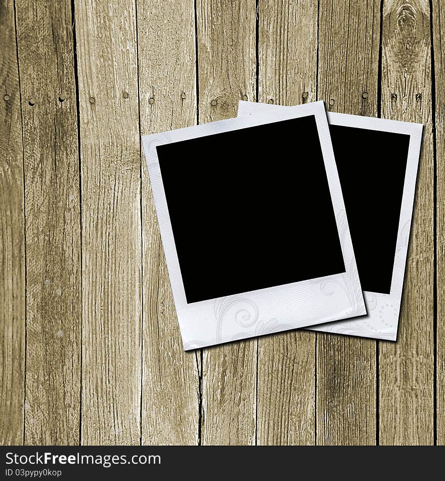 Two photo frames on wooden texture