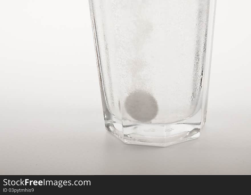 Glass of water with dropped sparkling fizzy tablet. Glass of water with dropped sparkling fizzy tablet