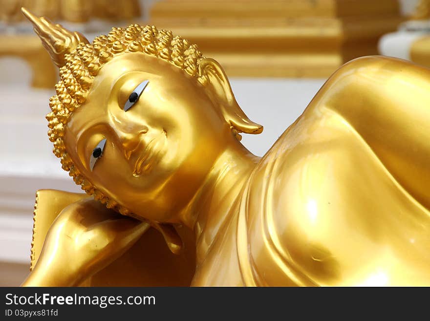 Reclining Buddha image in front of church, Wat Naga Wichai, Mahasarakam, Thailand