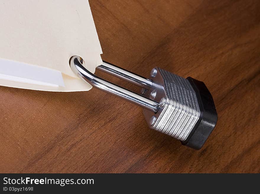 Manila folder closed with a metal lock. Manila folder closed with a metal lock.