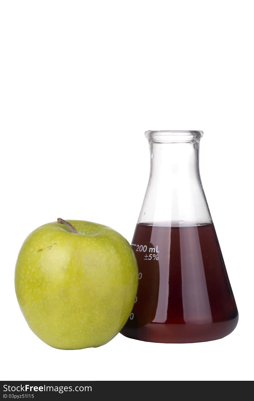 Green apple and an erlenmeyer flask with red liquid on a white background. Green apple and an erlenmeyer flask with red liquid on a white background.