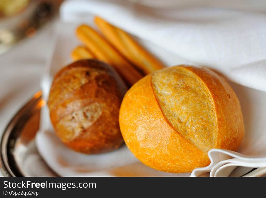 Macro shot of single french loaf with other variety of bread. Macro shot of single french loaf with other variety of bread.