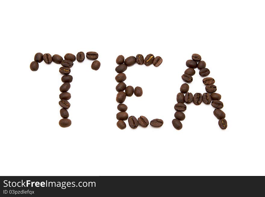 Word tea spelled with fried coffee beans