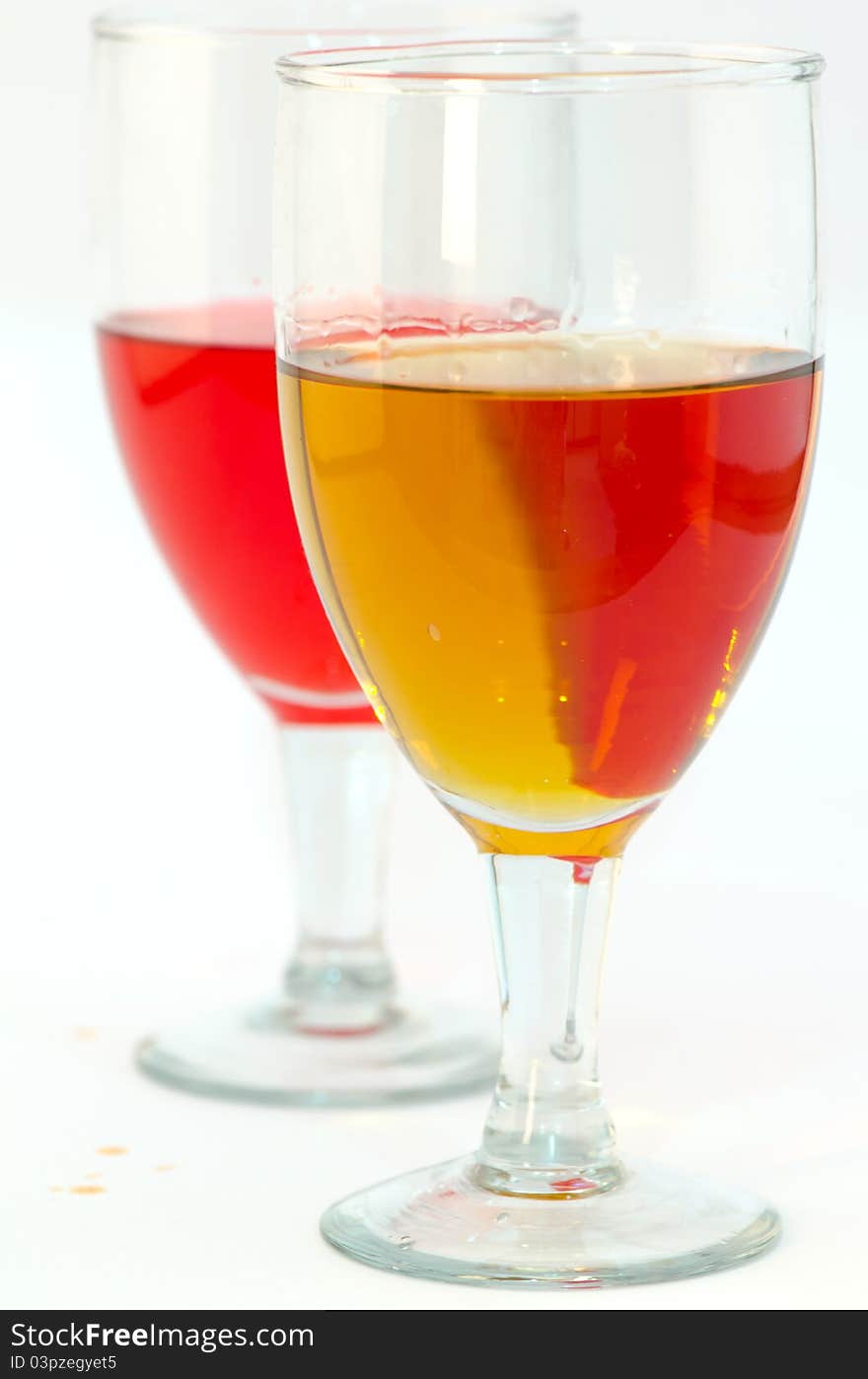 Isolated closeup of two glasses of red and white wines on white background. Isolated closeup of two glasses of red and white wines on white background