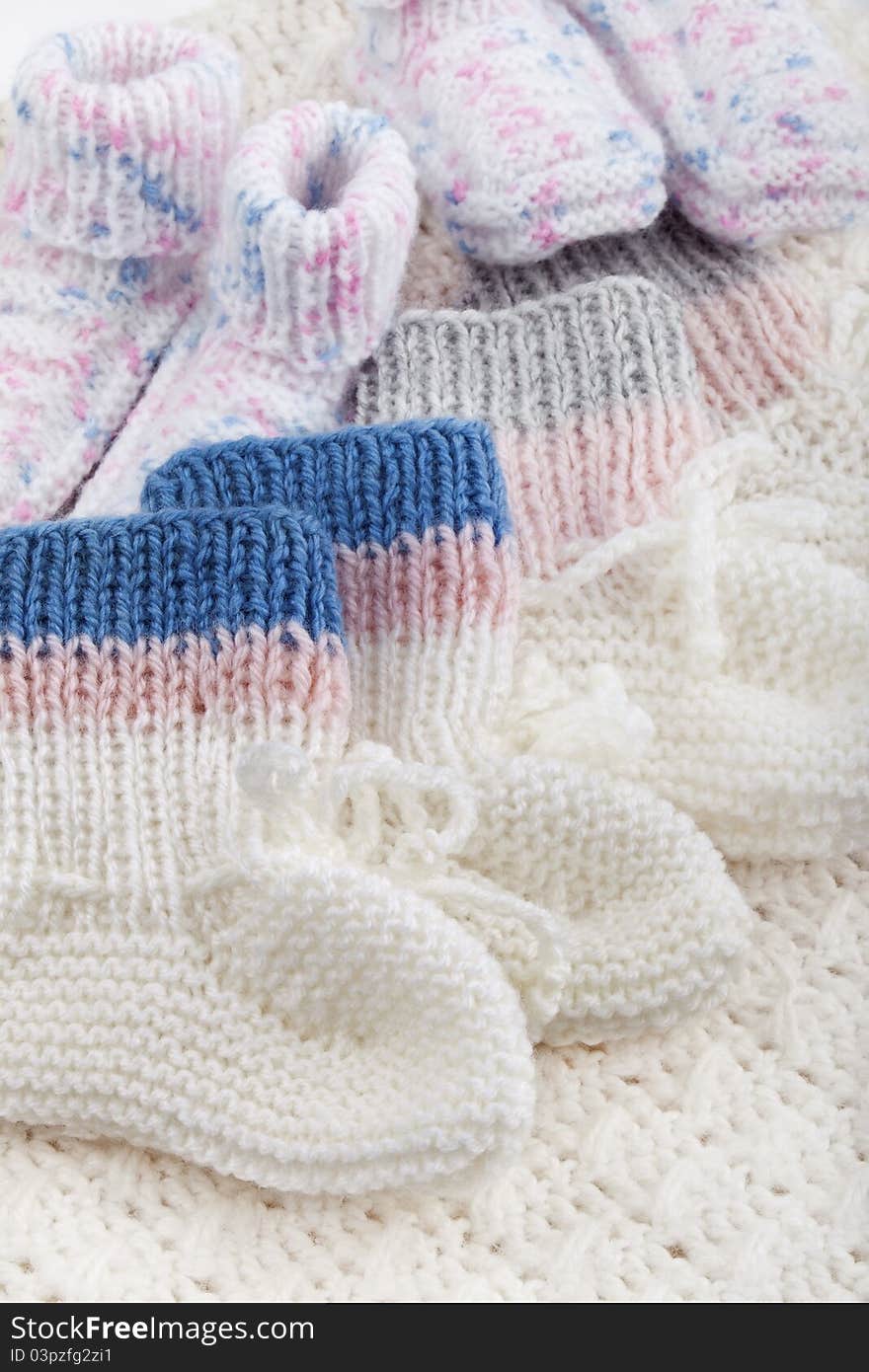 Studio-shot of selfmade hand-knitted woolen baby socks.