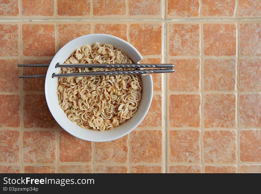 Bowl of Chinese soup on orange background